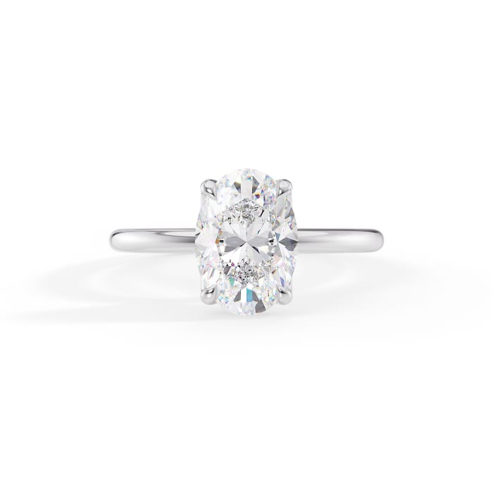 oval cut moissanite four prong solitaire engagement ring in 14k gold
