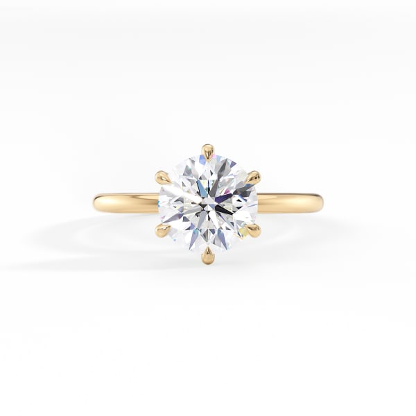 Gold ring with a large diamond on a white background