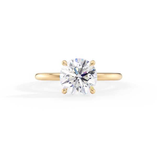 Gold ring with a large diamond on a white background