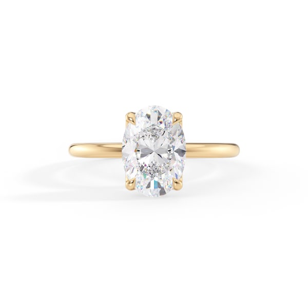 Gold ring with a large diamond on a white background