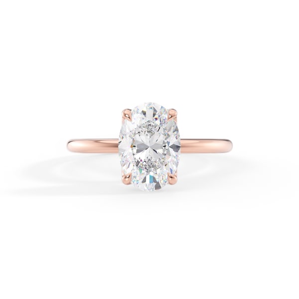 Rose gold ring with a large diamond on a white background