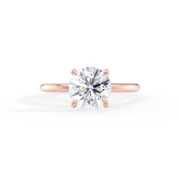 Rose gold ring with a large diamond on a white background
