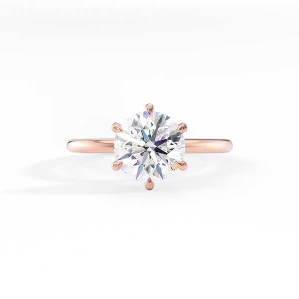 Rose gold ring with a large diamond on a white background