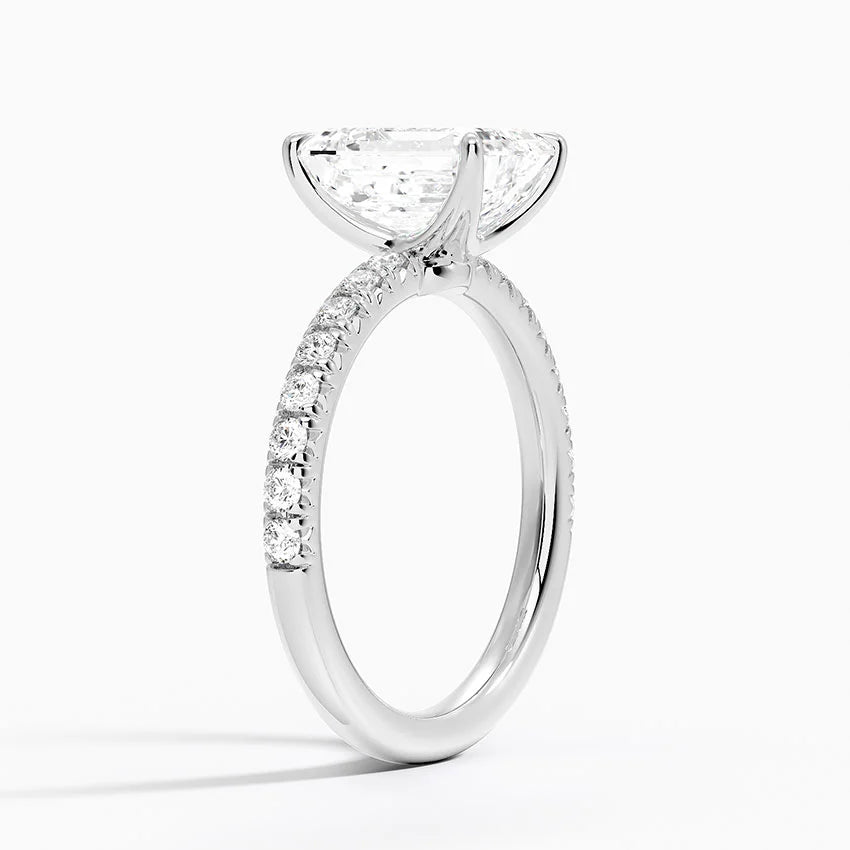 Diamond ring with a triangular cut center stone on a white background