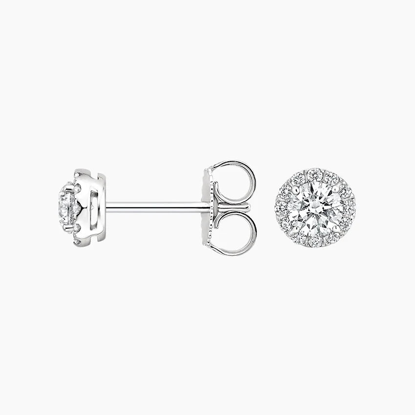 Classic round diamond halo earrings worn on ear